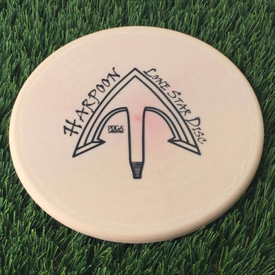 Solid light brown Lone Star Victor 2 Harpoon 171g flying disc with an arrow graphic and Harpoon stamp.