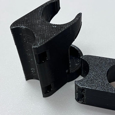 Two black Max Disctance Cart Clip XF10 165 disc golf clips with textured gripping surfaces.