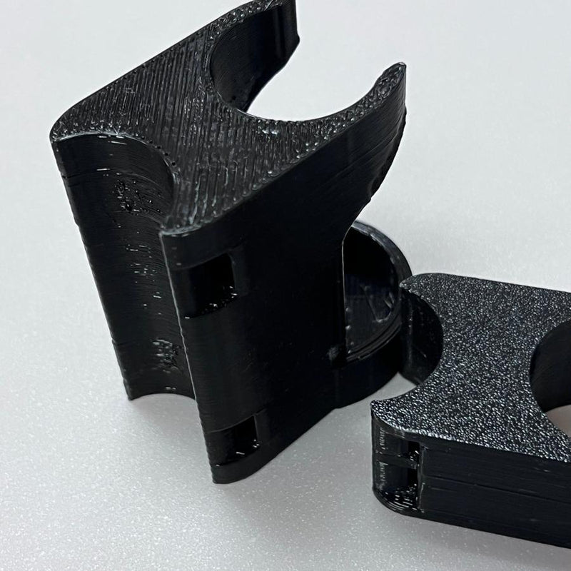 Two black Max Disctance Cart Clip XF10 165 disc golf clips with textured gripping surfaces.