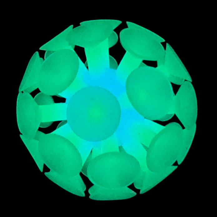 Glow-in-the-dark suction ball attachment with numerous teal suction cups clustered around a central blue hub.