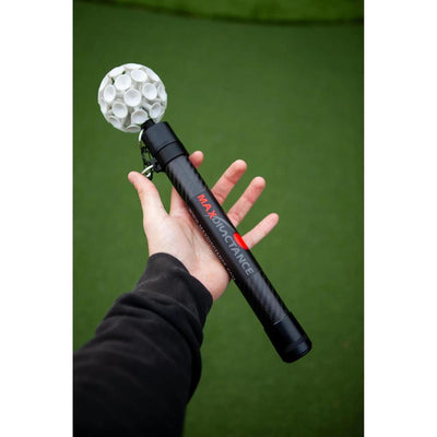 Person holding a black carbon fiber Maxdisctance Maxstick ball retriever with a white textured suction cup head.
