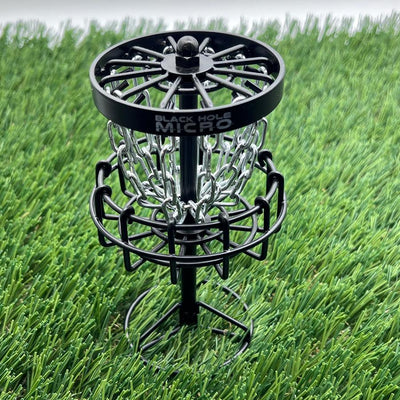 MVP Black Hole Micro disc golf basket with a circular outer band, radial wire spokes, and silver chains.