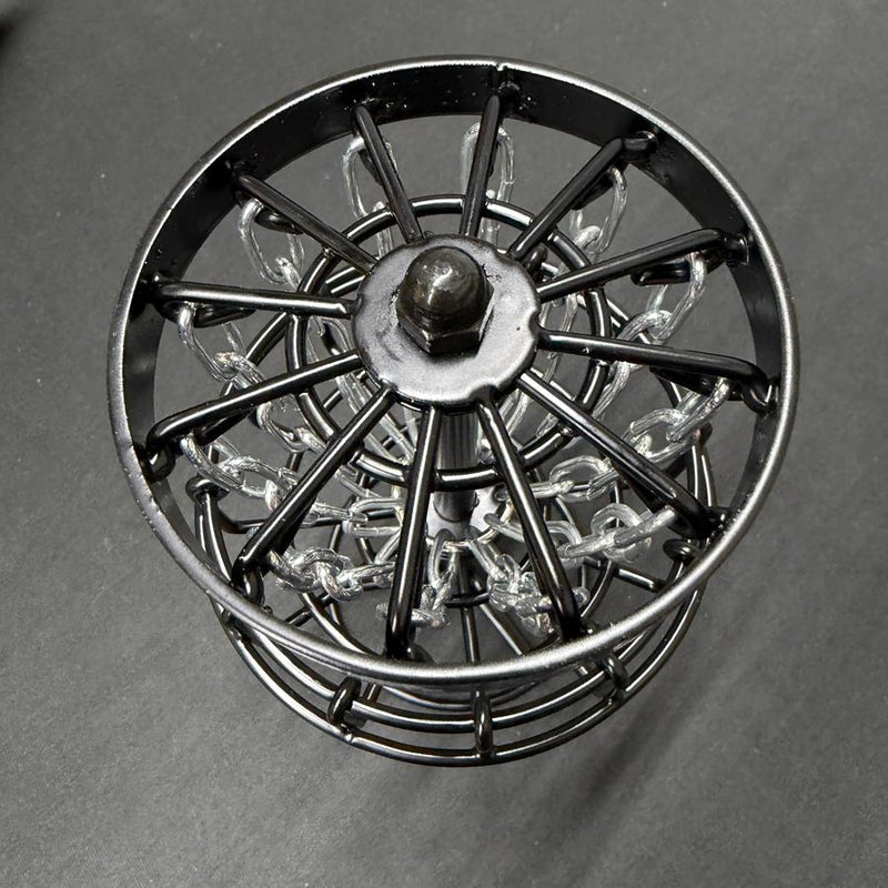 MVP Black Hole Micro disc golf basket with a black metal frame, shiny silver chains, and a dark metal base.