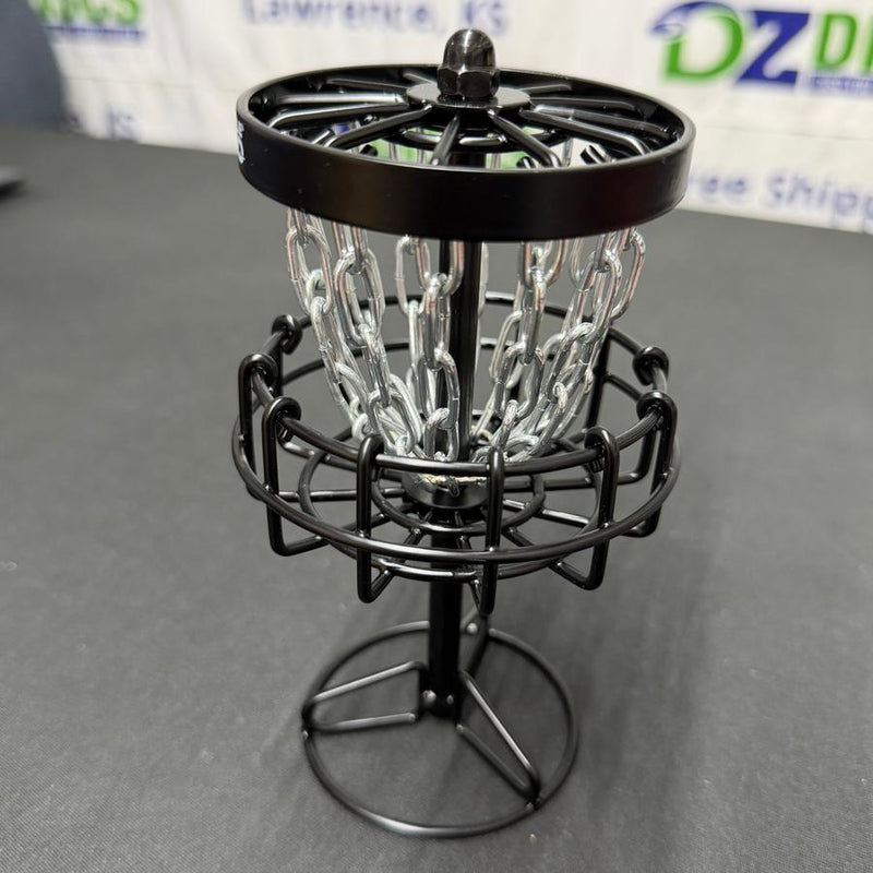Black MVP Black Hole Micro disc golf basket with silver chains and a sturdy metal frame.