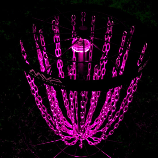 Mvp black lunar module disc golf basket with neon pink illuminated chains and a bright pink inner light glowing in the dark.