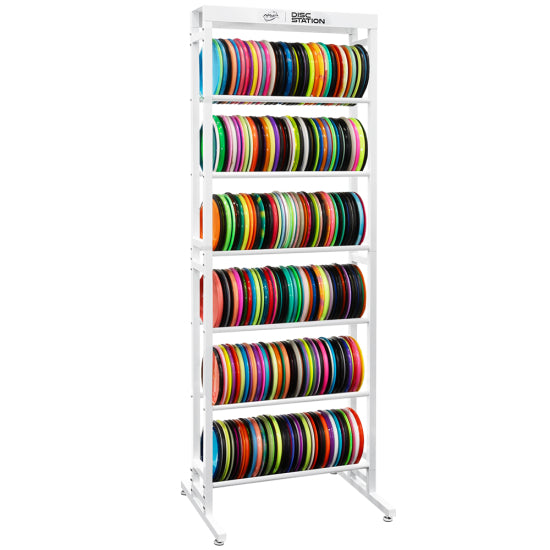 White MVP Disc Station storage rack with six shelves filled with a variety of colorful disc golf discs.