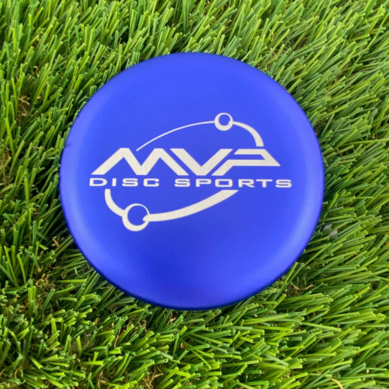 Royal blue MVP disc sports metal marker with a white orbit logo on a flat, circular surface.