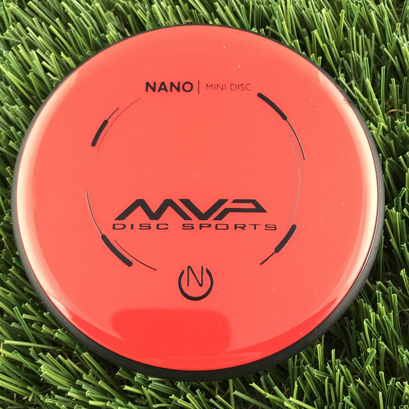 Vibrant orange MVP Nano Mini Neutron disc golf marker with a black overmold and black MVP branding.