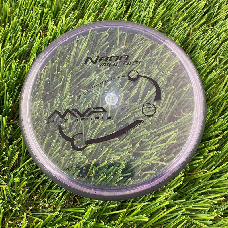 Clear MVP Nano Proton mini marker disc with black MVP logo, glitter flecks, and a dark purple rim.