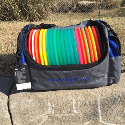 Grey MVP Nucleus Deluxe Tournament Bag filled with a rainbow assortment of colorful disc golf discs.