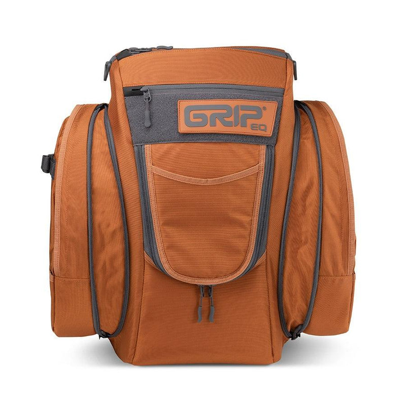 Orange and grey grip eq cx1 series disc golf bag with pockets and a zipper on the front.