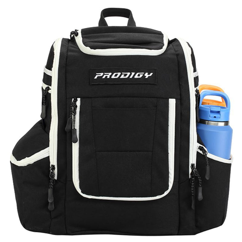 Black Prodigy Apex XL Luxury Bag with white trim, a top flap pocket, and a blue water bottle in the side pocket.