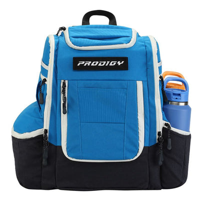 Bright blue and black Prodigy Apex XL Luxury Bag with white trim, zippered pockets, and a water bottle holder on the side.
