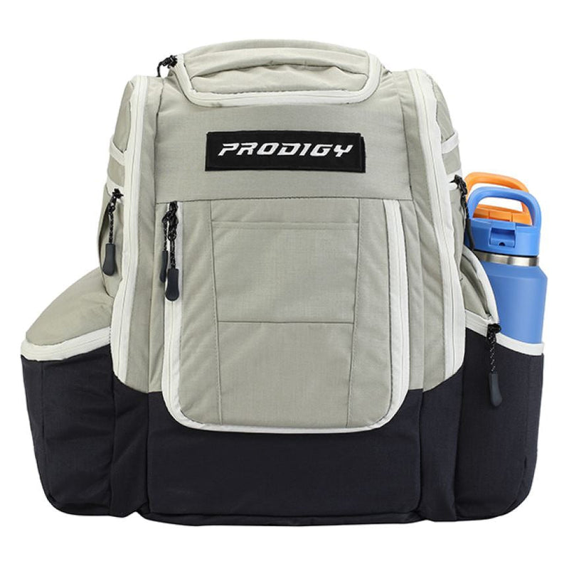 Light gray and black Prodigy Apex XL Luxury Bag with zippered pockets and a blue water bottle.