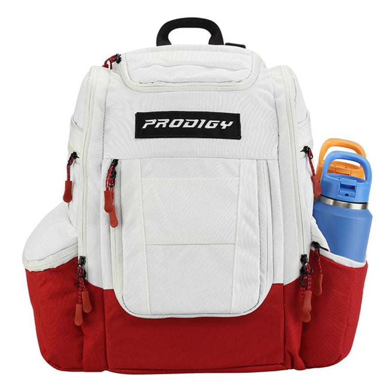 White and red Prodigy Apex XL Luxury Bag with zippered pockets, a black handle, and an external water bottle holder.