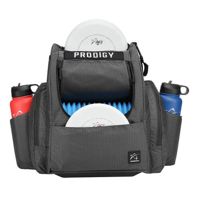 Dark gray Prodigy BP-2 V3 disc golf backpack with two white discs and red and blue water bottles.