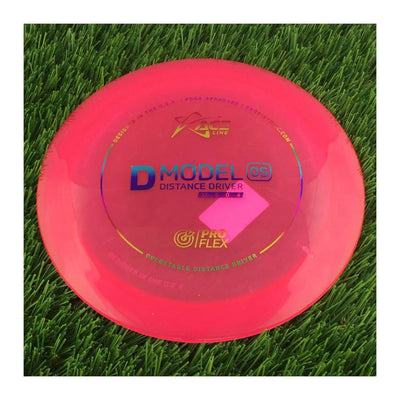 Translucent pink Prodigy D Model OS ProFlex disc golf distance driver with blue and yellow stamp details.