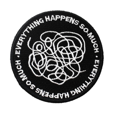 Circular black embroidered iron on patch with white tangled lines, and "EVERYTHING HAPPENS SO MUCH" text.