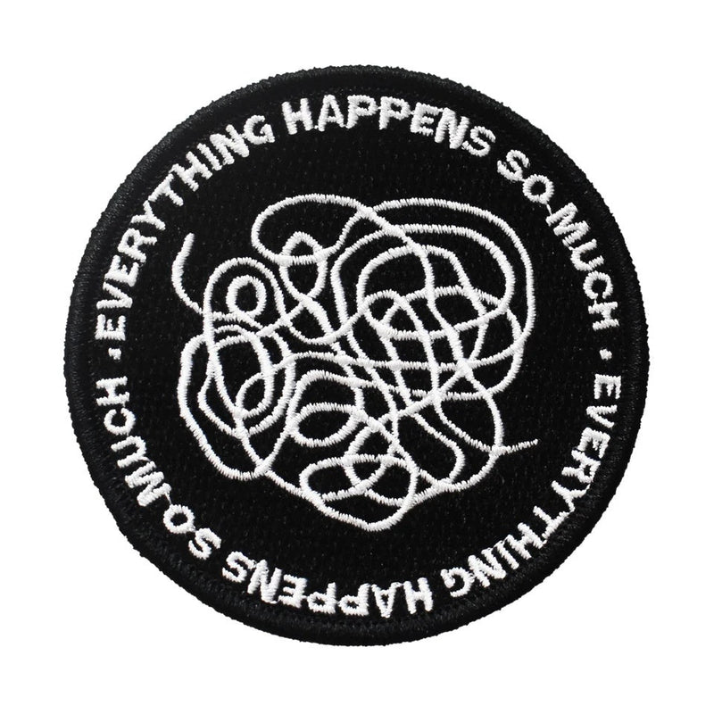 Circular black embroidered iron on patch with white tangled lines, and "EVERYTHING HAPPENS SO MUCH" text.