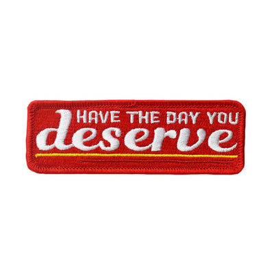 Retrograde "Have the Day You Deserve" iron-on patch with red fabric and white and yellow embroidered text.