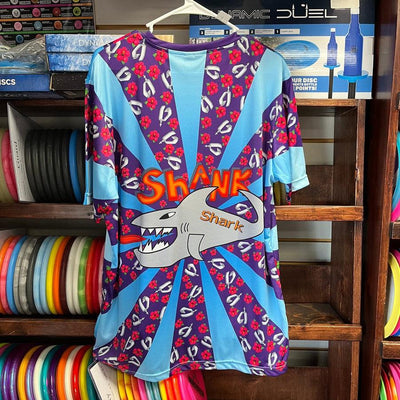 Purple and blue "Shank Shark" jersey with red flowers and a toothy grey shark with an orange tongue.
