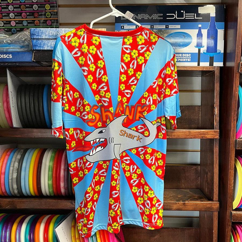 The light blue and red Shank Shark printed jersey features a shark graphic "Shark" text and red hibiscus flowers.