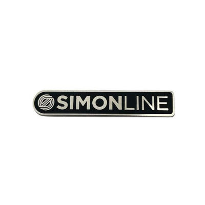 Black and white "SIMONLINE" bar stamp enamel pin with a stylized "S" logo for collector's apparel.