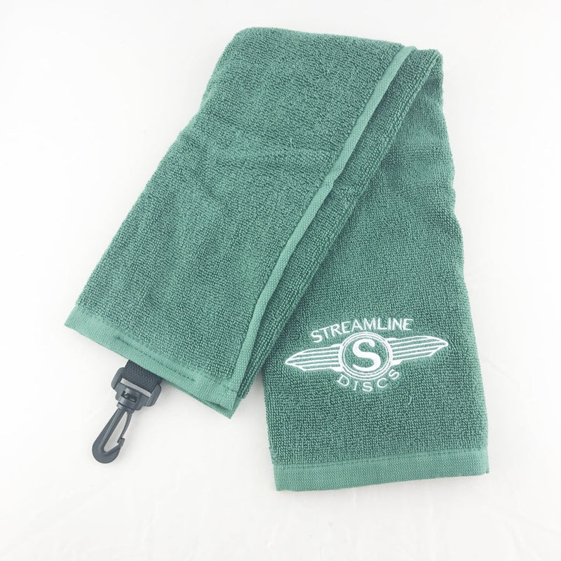 Green terry cloth Streamline Discs Tri-Fold Wings logo towel with a black plastic carabiner clip.