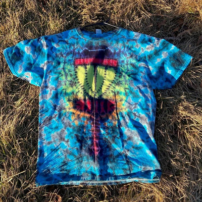 Tie-dye t-shirt in vibrant blues and greens featuring a yellow disc golf basket with red and orange accents.