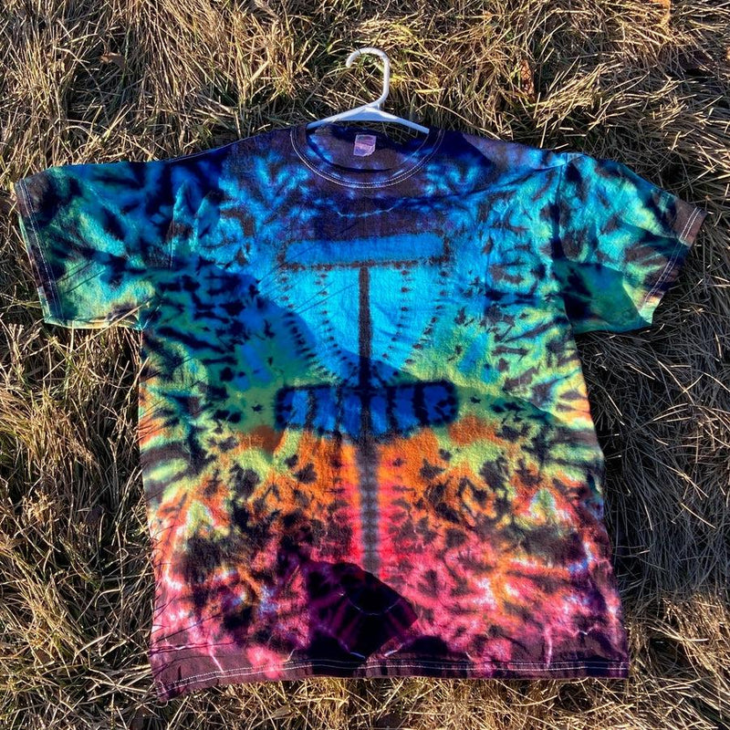 A short-sleeved tie-dye t-shirt displays a dark blue disc golf basket graphic against bright multicolored swirls.