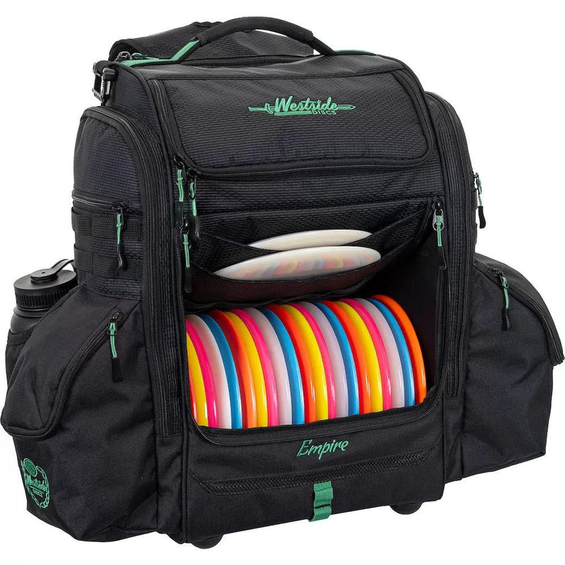 Black Westside Discs Empire backpack disc golf bag with colorful discs and green accents and zippers.