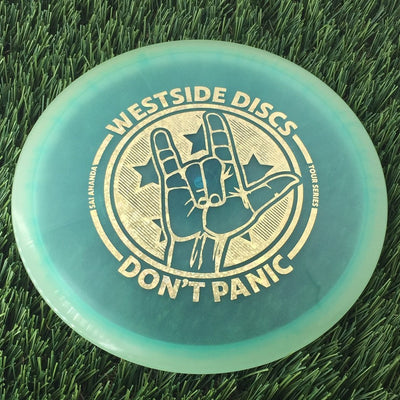 Translucent turquoise blue Westside Discs Gatekeeper disc golf disc with a gold "Don't Panic" hand stamp.