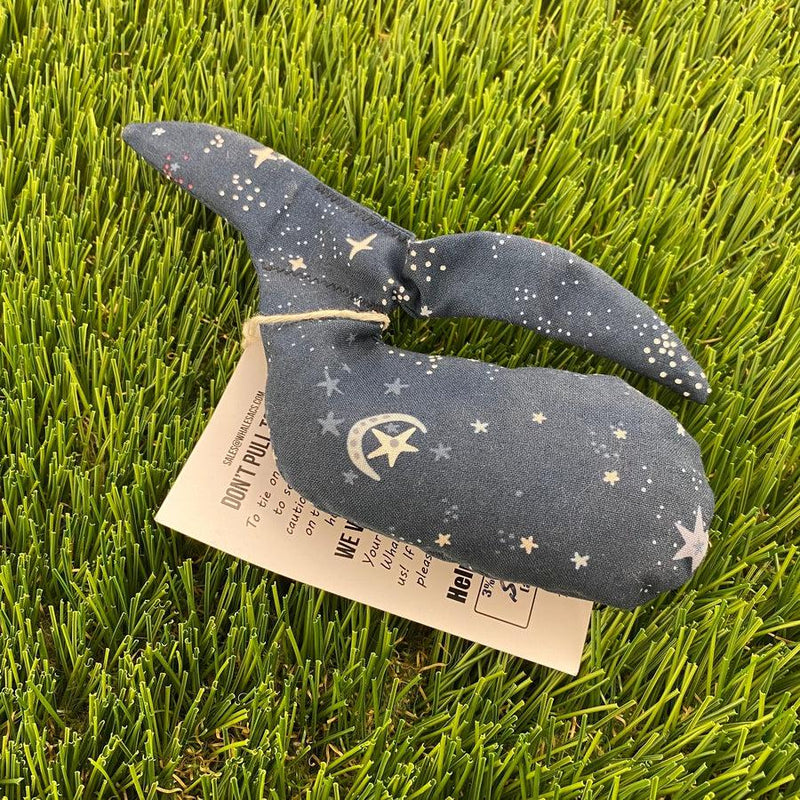 Dark blue Whale Sacs Grip Bag with white stars and moons on a hanging product tag.