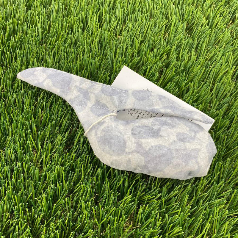 A grey and white patterned Whale Sacs grip bag tied with a string, featuring printed instructions visible on the folded tag.