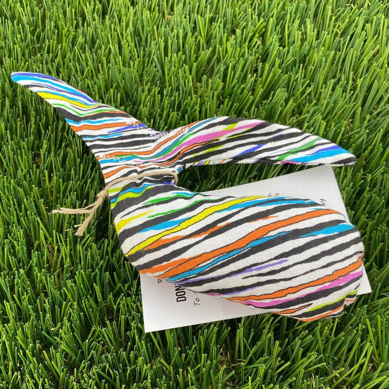 Colorful Whale Sacs grip bag with vibrant rainbow stripes and black zebra patterns.