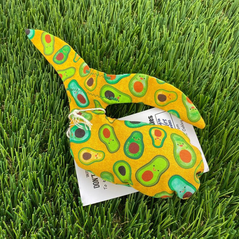 Yellow fabric Whale Sac grip bag with a whimsical avocado pattern and white drawstring detail.