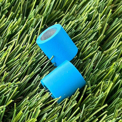 Two ZUCA backpack cart large wheel spacers in bright blue with dark gray metal interiors are arranged diagonally.