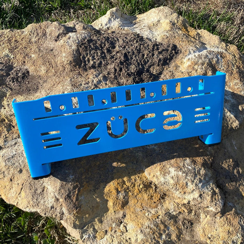Bright blue ZUCA backpack disc golf cart frame featuring a cutout logo and rectangular slots.