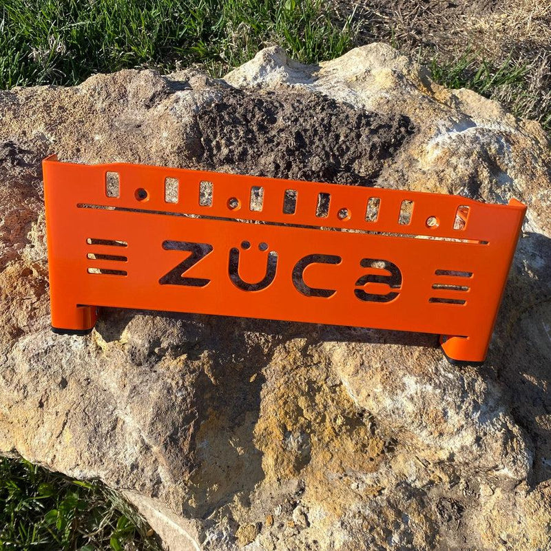 Bright orange ZUCA front wrapper backpack disc golf cart frame with a cutout logo and black leg caps.