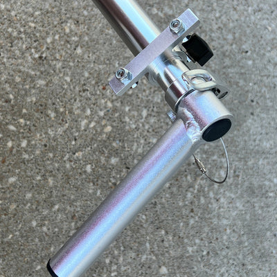 Silver ZUCA Cart telescoping handle set showing tubes, shiny metal clamps, and black knobs on a handle bar.