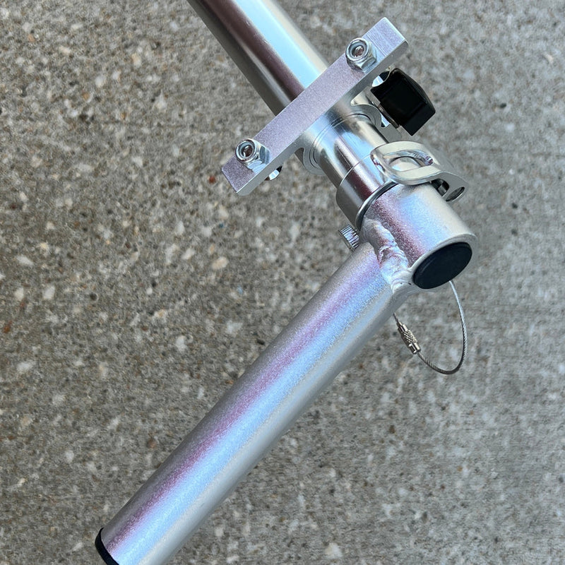 Silver ZUCA Cart telescoping handle set showing tubes, shiny metal clamps, and black knobs on a handle bar.