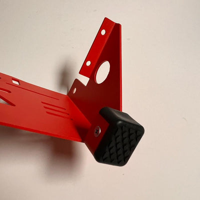 Close-up of a Zuca Front Wrapper Backpack LG Disc Golf Cart's red metal frame with a black rubber foot.