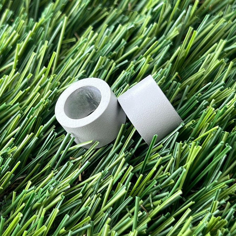 Two gray cylindrical ZUCA backpack cart wheel spacers made of durable plastic are shown.