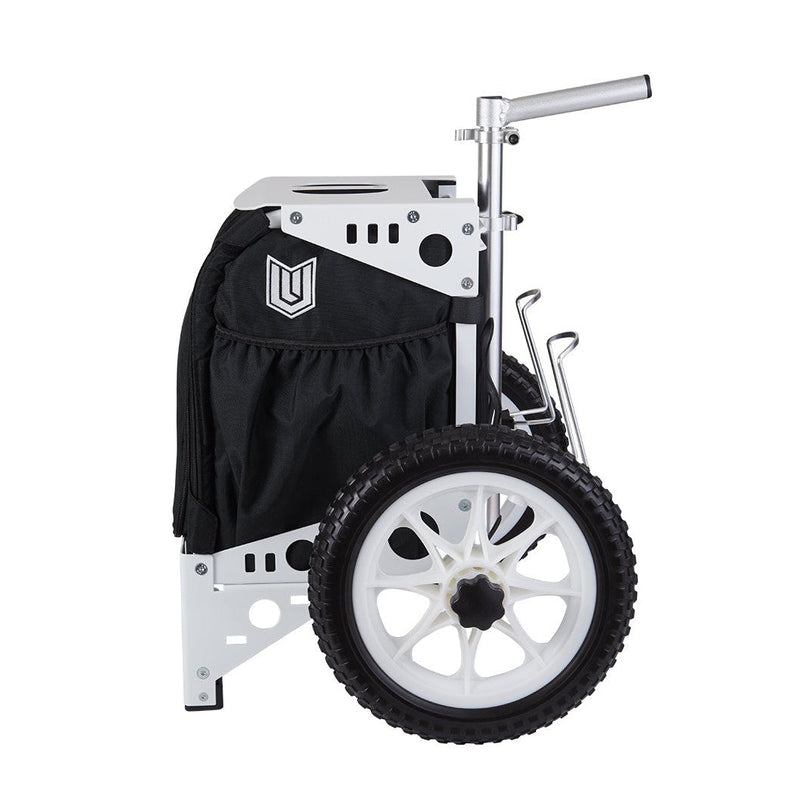 White Zuca Compact Paul Ulibarri disc golf cart with black bag and large white wheels on profile.