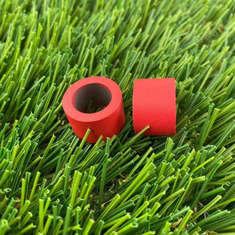 Pair of red cylindrical ZUCA backpack cart wheel spacers with a dark gray interior.