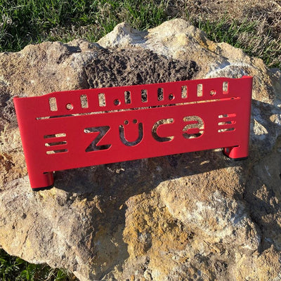 Red ZÜCA Front Wrapper disc golf backpack cart frame featuring a cutout logo and black rubber feet.