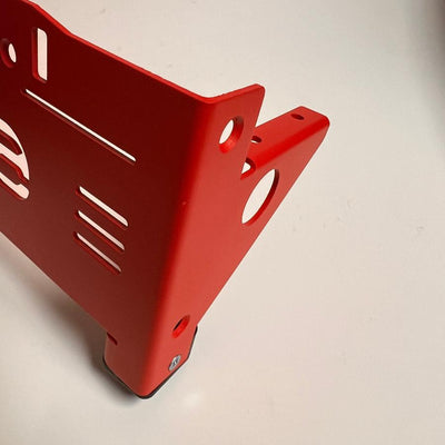 Red powder coated Zuca front wrapper for a backpack disc golf cart, featuring numerous cutouts and mounting holes.
