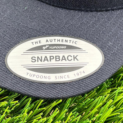 Yupoong / Kastaplast L'authentique chapeau Snapback en tissu