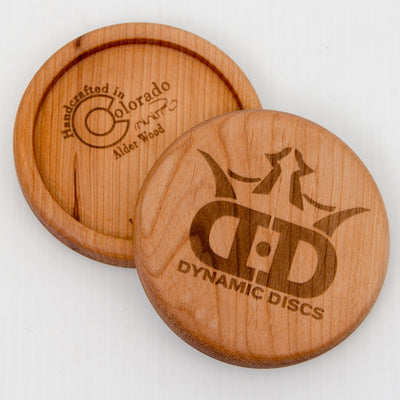 Front and back views of a Dynamic Discs Alder Wood Mini disc golf marker.